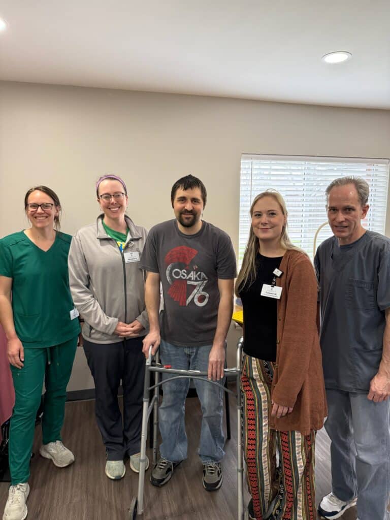 Patient Kyle posing with the Pathways medical team